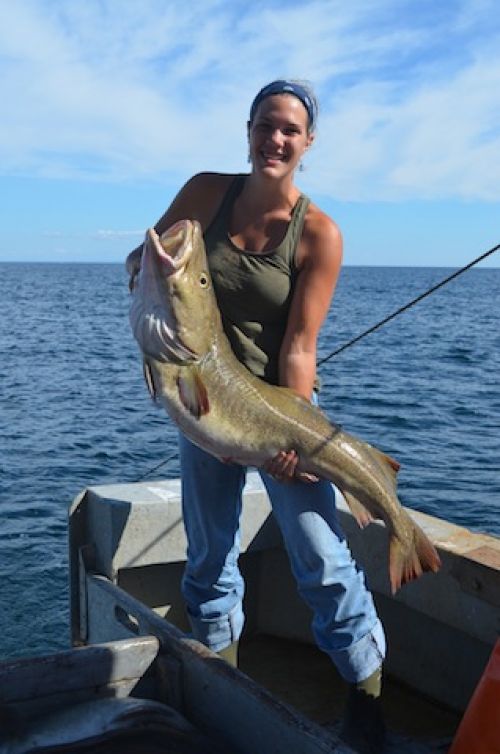Sarah VanHorn holding a cod aboard Rimrack